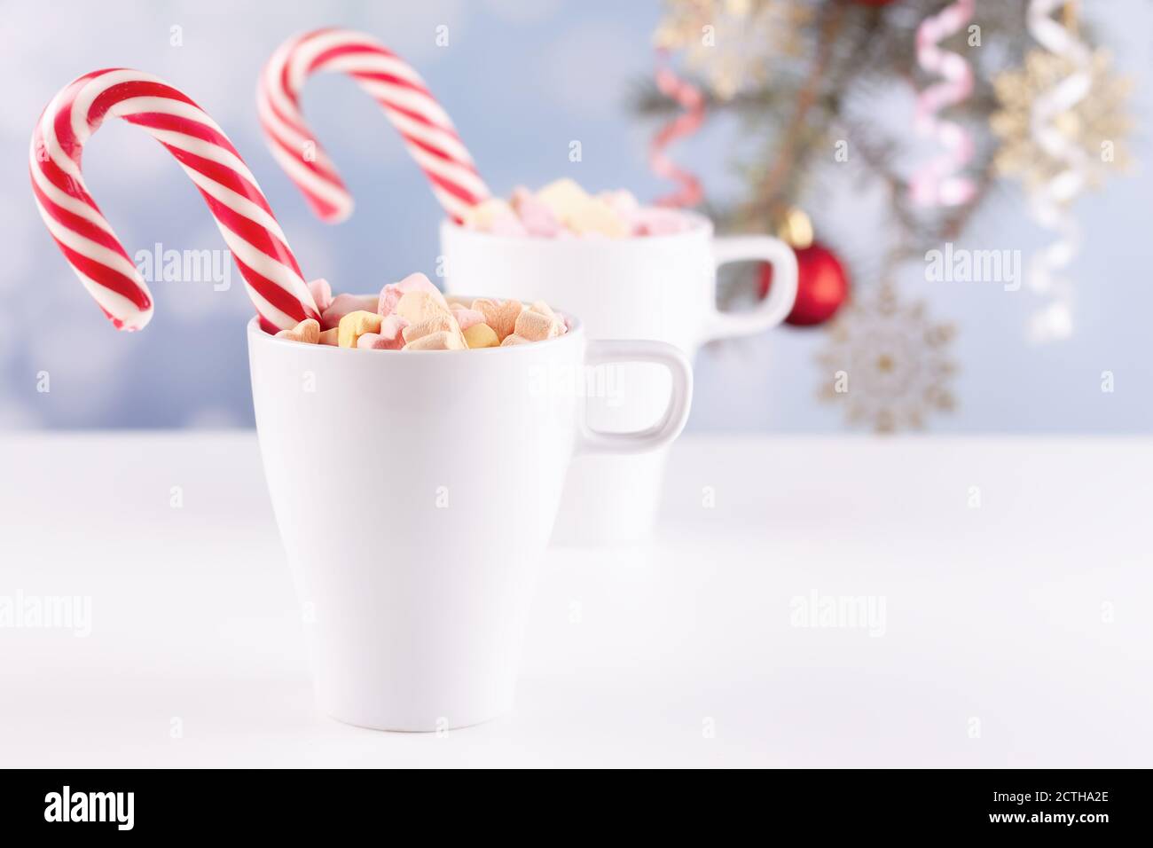 marshmallows and a cup of latte on a white table Stock Photo