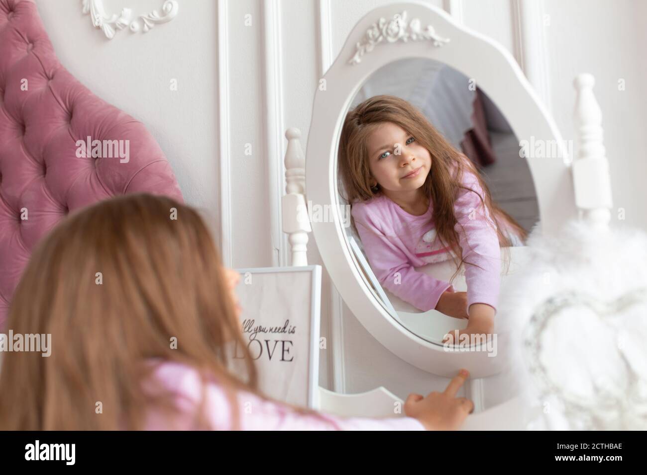 Beautiful teenage girl at the bedside mirror Stock Photo - Alamy