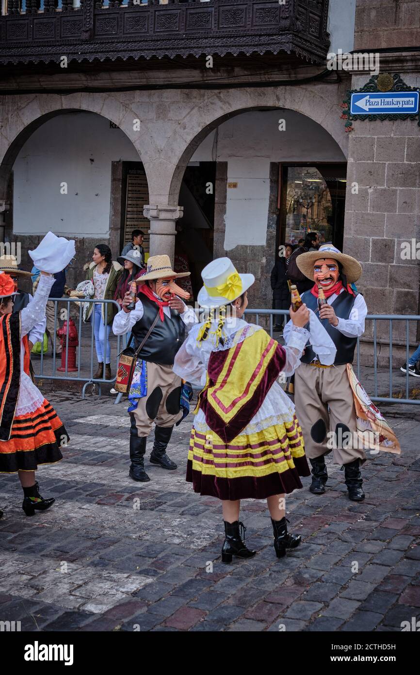 Men and women in fancy dress costumes and masks dancing in a procession during the Inti Raymi'rata sun festival over the winter solstice, Cusco, Peru Stock Photo