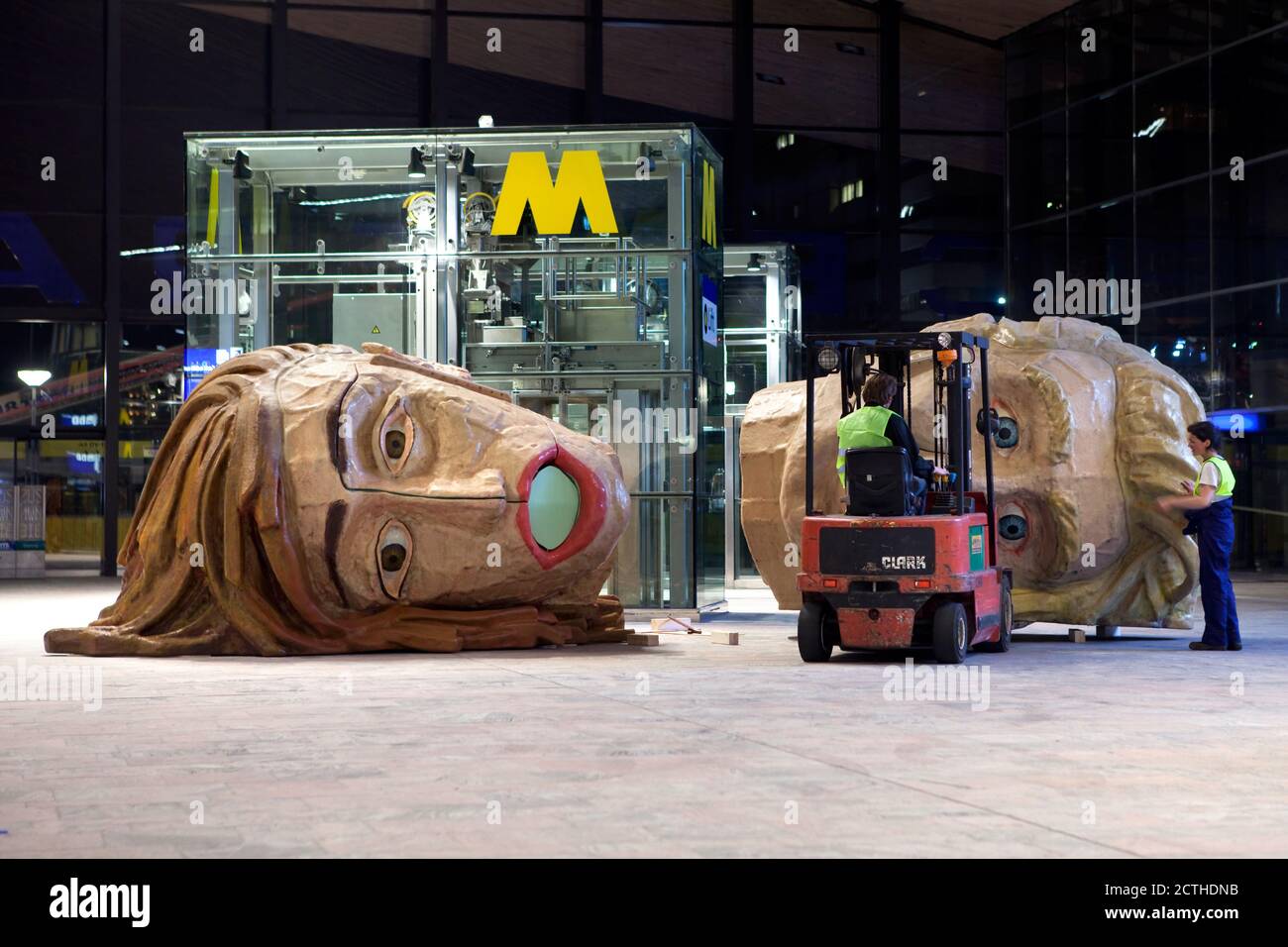 ROTTERDAM - Placing of giant heads by art studio van Lieshout in the central station Stock Photo