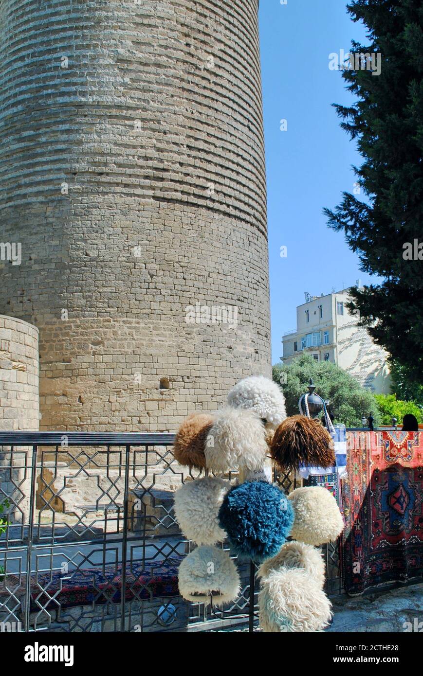 A display of traditional Azeri, Caucasian souvenir sheep wool Papakha hats  and rags in front of Maiden Tower. The Walled City in Baku, Azerbaijan  Stock Photo - Alamy