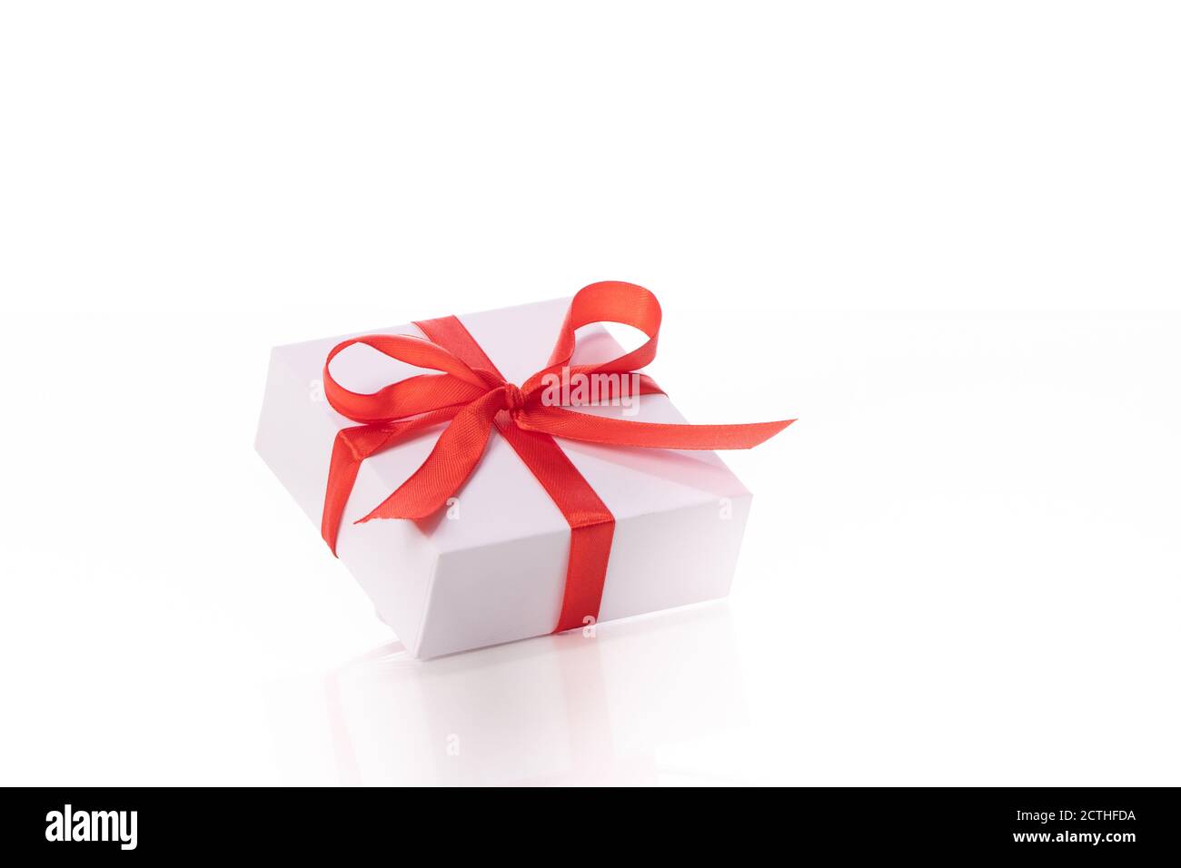 Beautiful white gift box with red bow isolated on white background ...