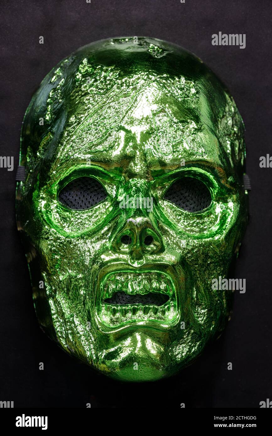 Metallic Green Zombie Mask Isolated Against Black Background Stock Photo
