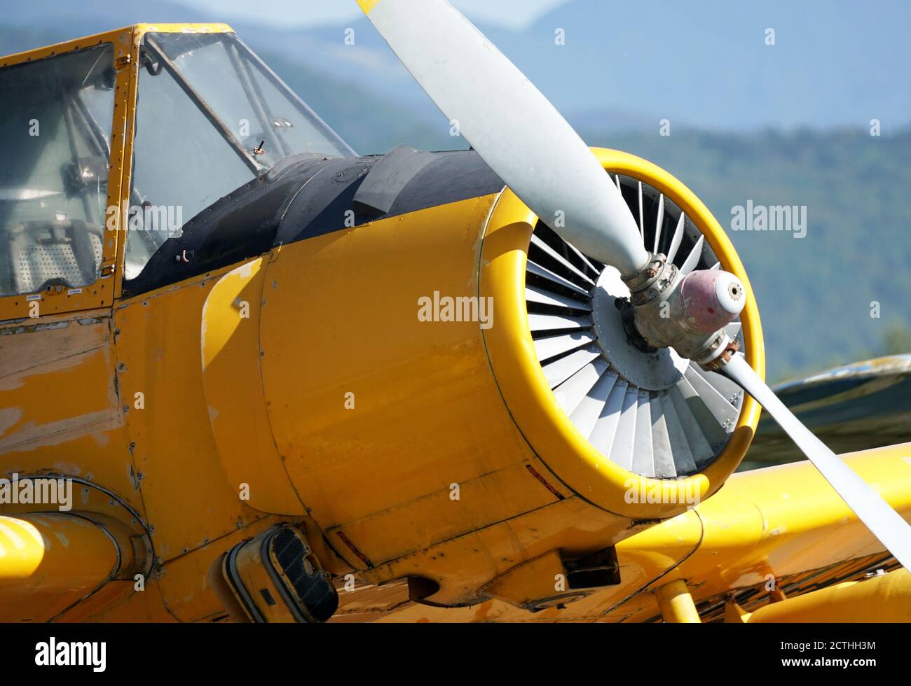 Single concept image of an yellow air-plane with reflections of the sun and copy space close-up shot. Stock Photo