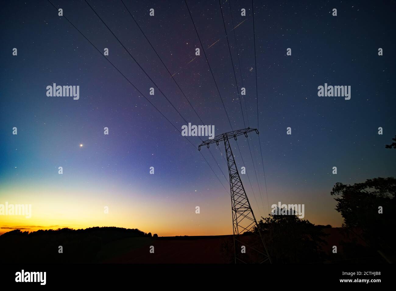 Night landscape with power lines on the starry sky Stock Photo - Alamy