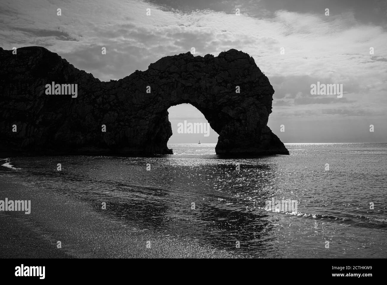Late afternoon silhouetted view of the picturesque Durdle Door rock formation on the Jurassic Coast World Heritage site in Dorset, south-west England Stock Photo