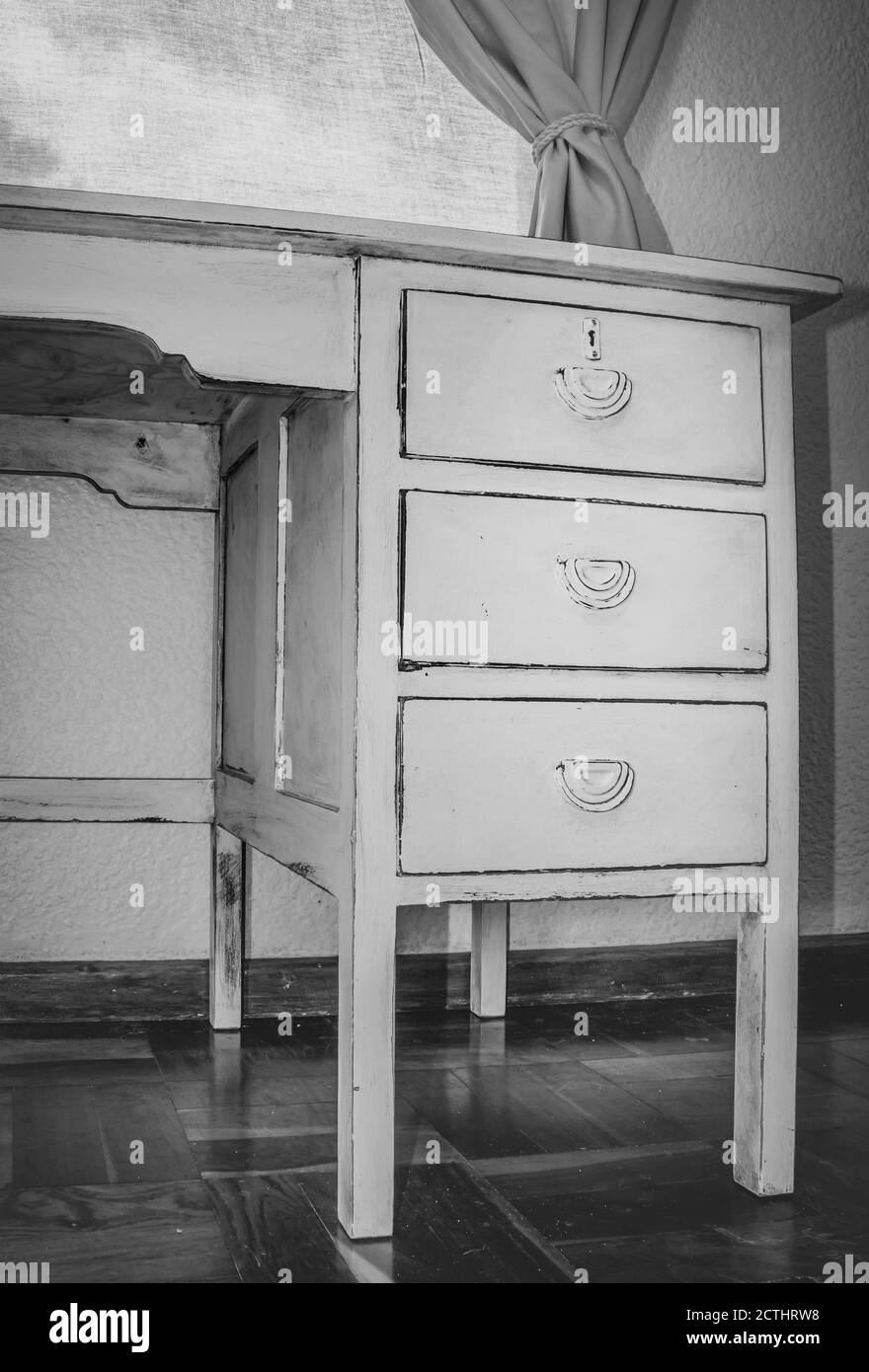 Old White wooden work desk, with three draws, inside a bedroom, South
