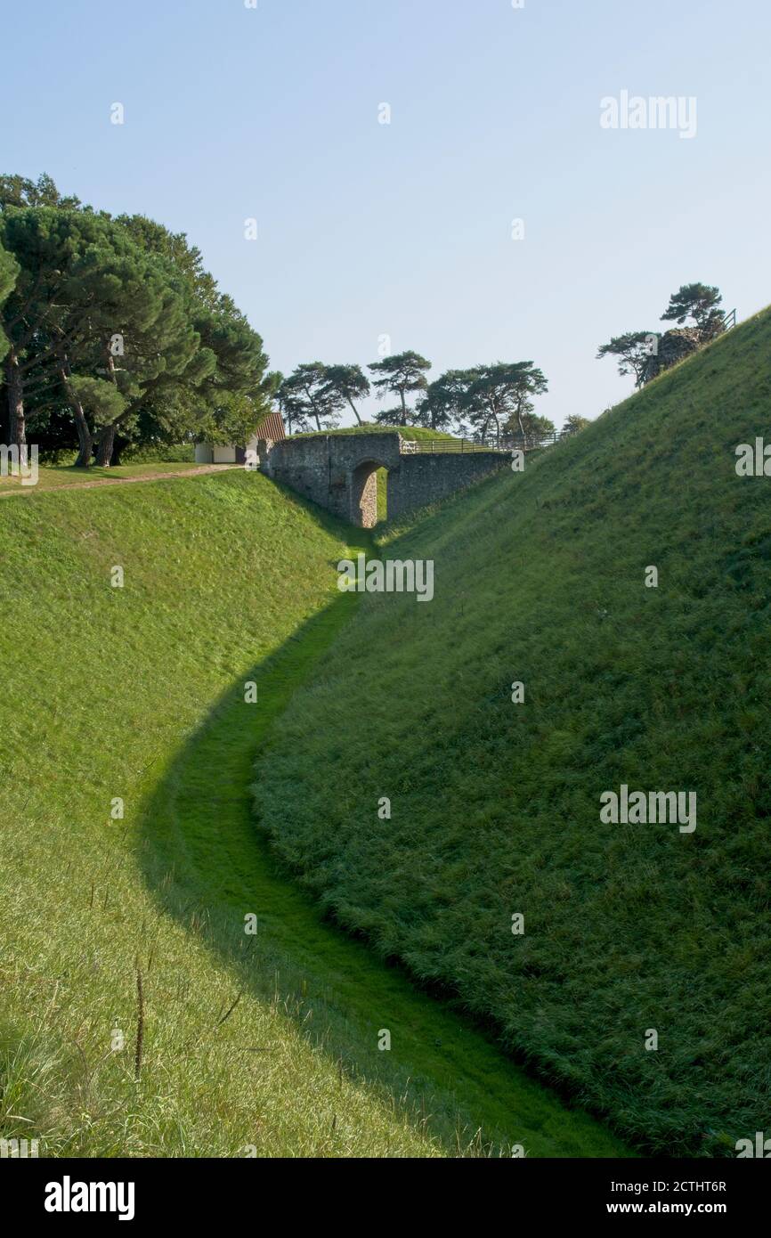 Castle Rising showing defensive moat now dry and grassed over. Stone ...