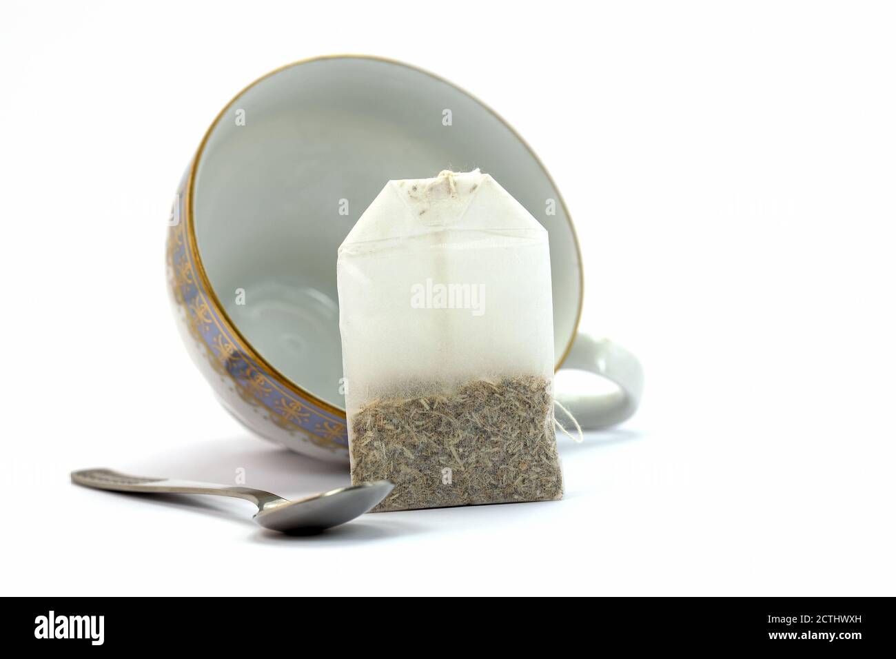 Tea bag, cup and teaspoon against a white background Stock Photo Alamy