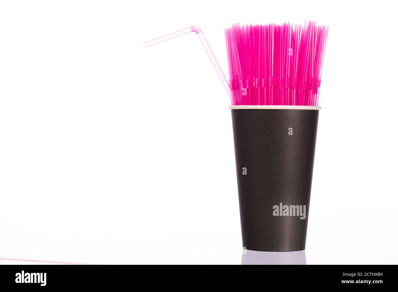 Bunch of pink plastic straws in black disposable biodegradable paper
