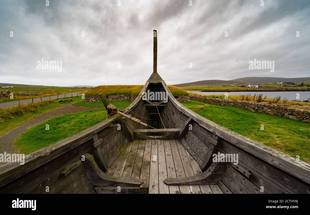 Viking longhouses and reconstructed Viking longboat at Haroldswick, Unst, Shetland, Scotland, UK Stock Photo