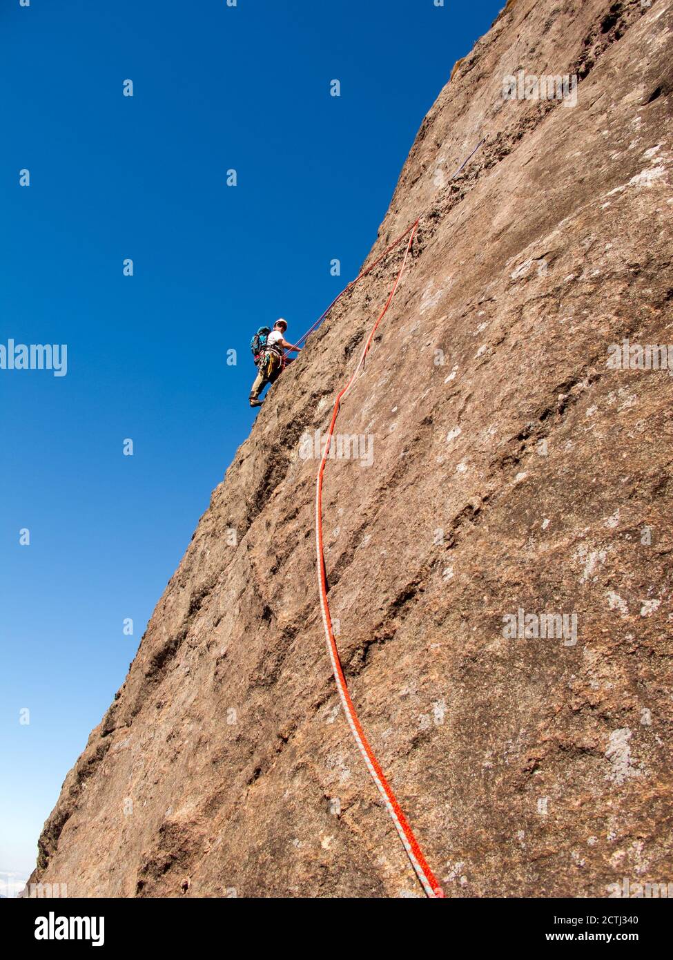 Rock climber climbing a sloping rock wall in Brazil Stock Photo Alamy