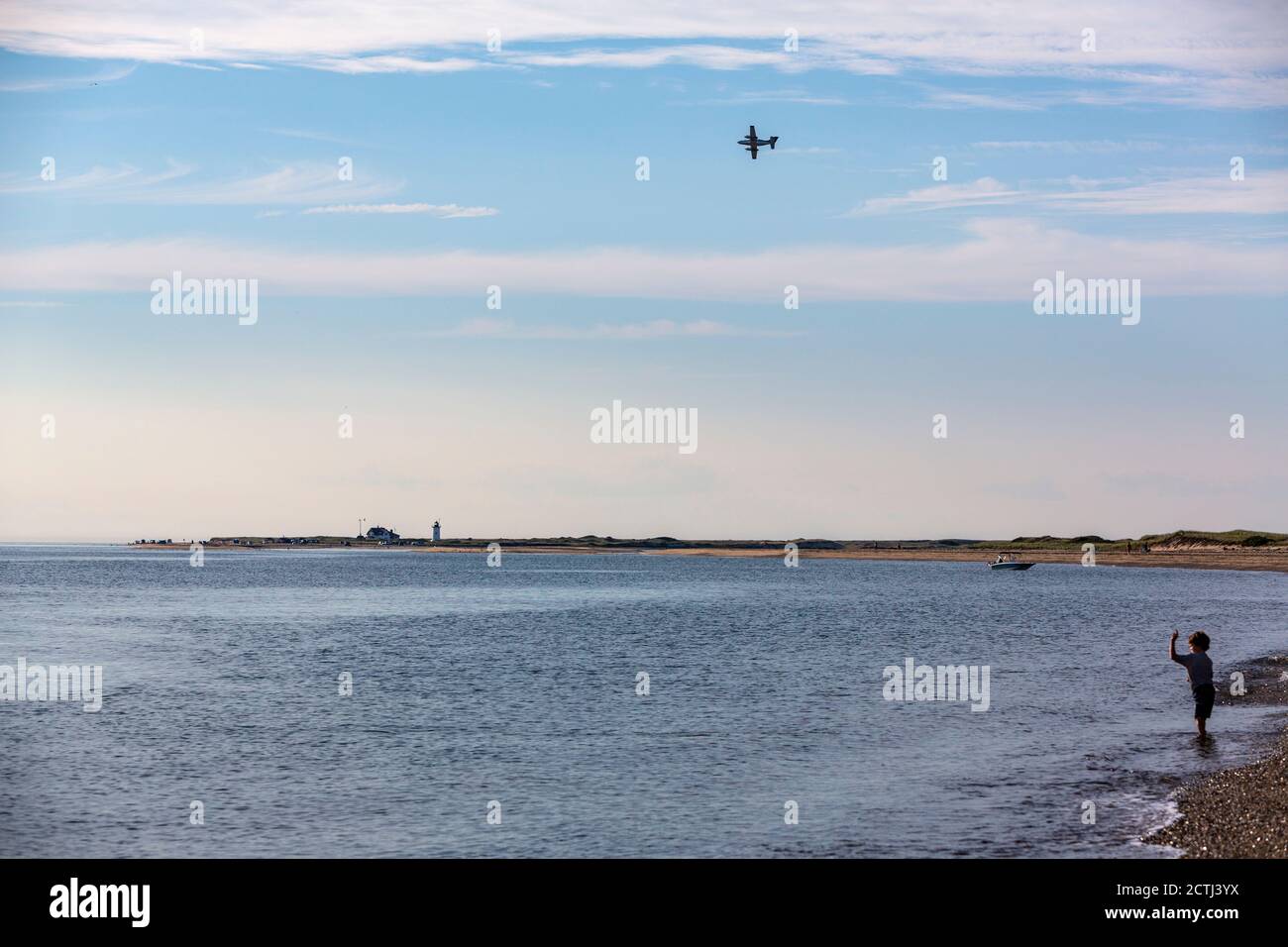 Boy waving to a plane in Herring Cove Beach, Provincetown