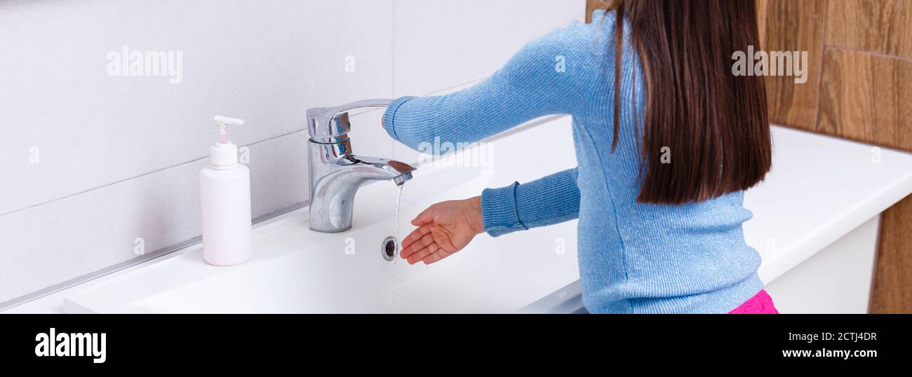 Little girl is washing her hands in the bathroom Stock Photo - Alamy