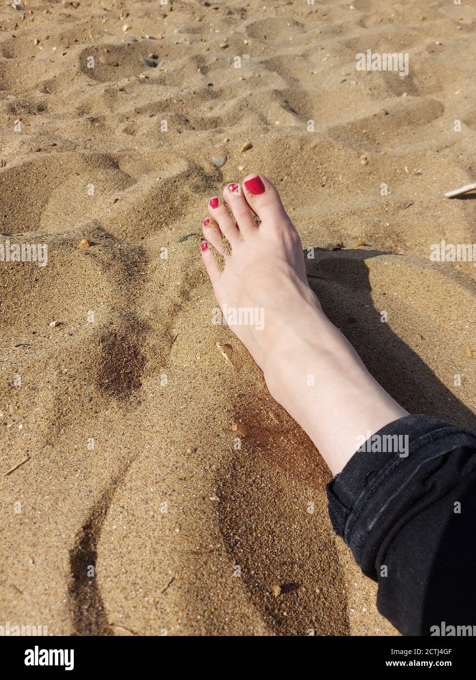 Sand between her toes, woman's foot on a beach Stock Photo Alamy