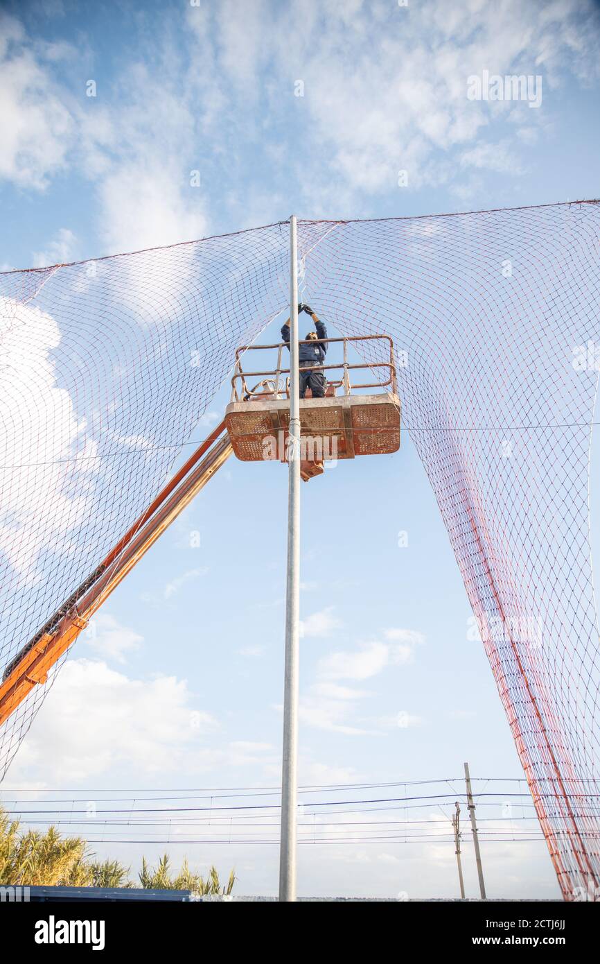 Vertical low angle shot of a man working at a construction site ...