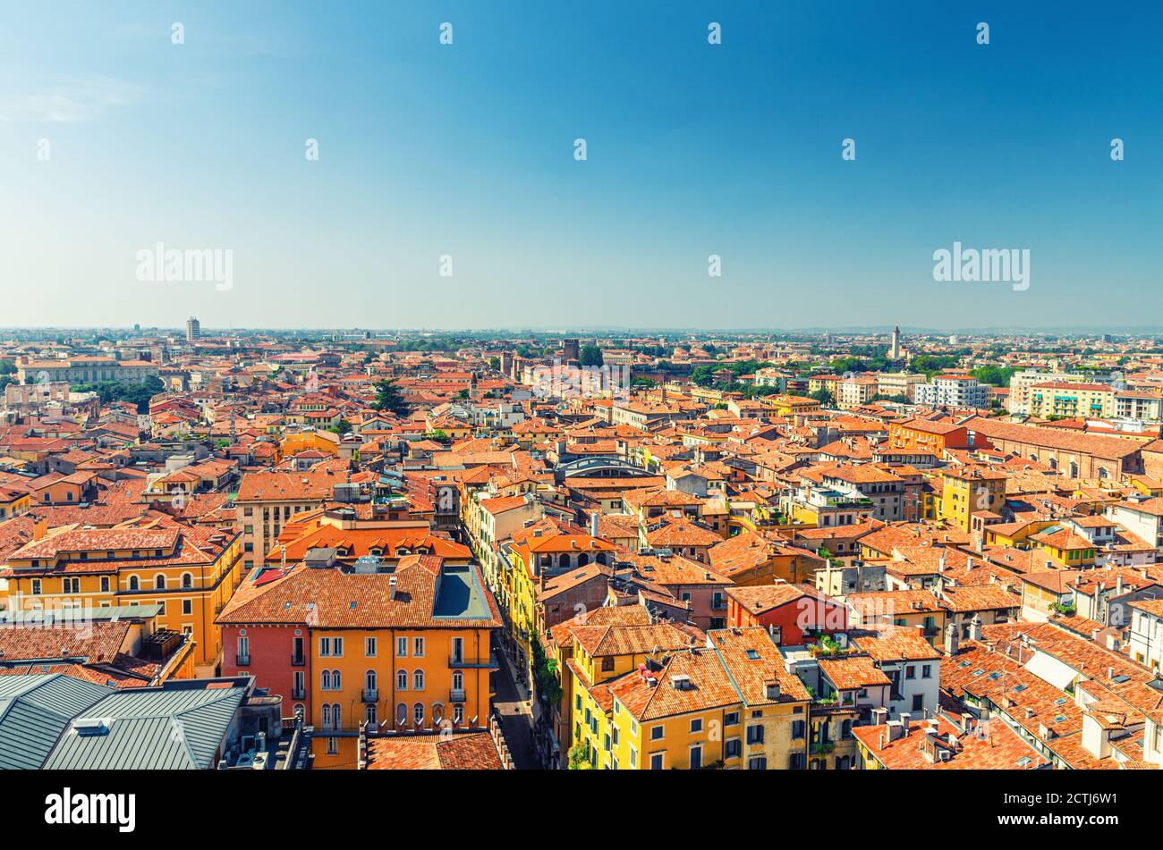 Aerial view of Verona city historical centre Citta Antica with red tiled roof buildings. Panoramic view of cityscape of Verona town. Blue sky background copy space. Veneto Region, Northern Italy Stock Photo