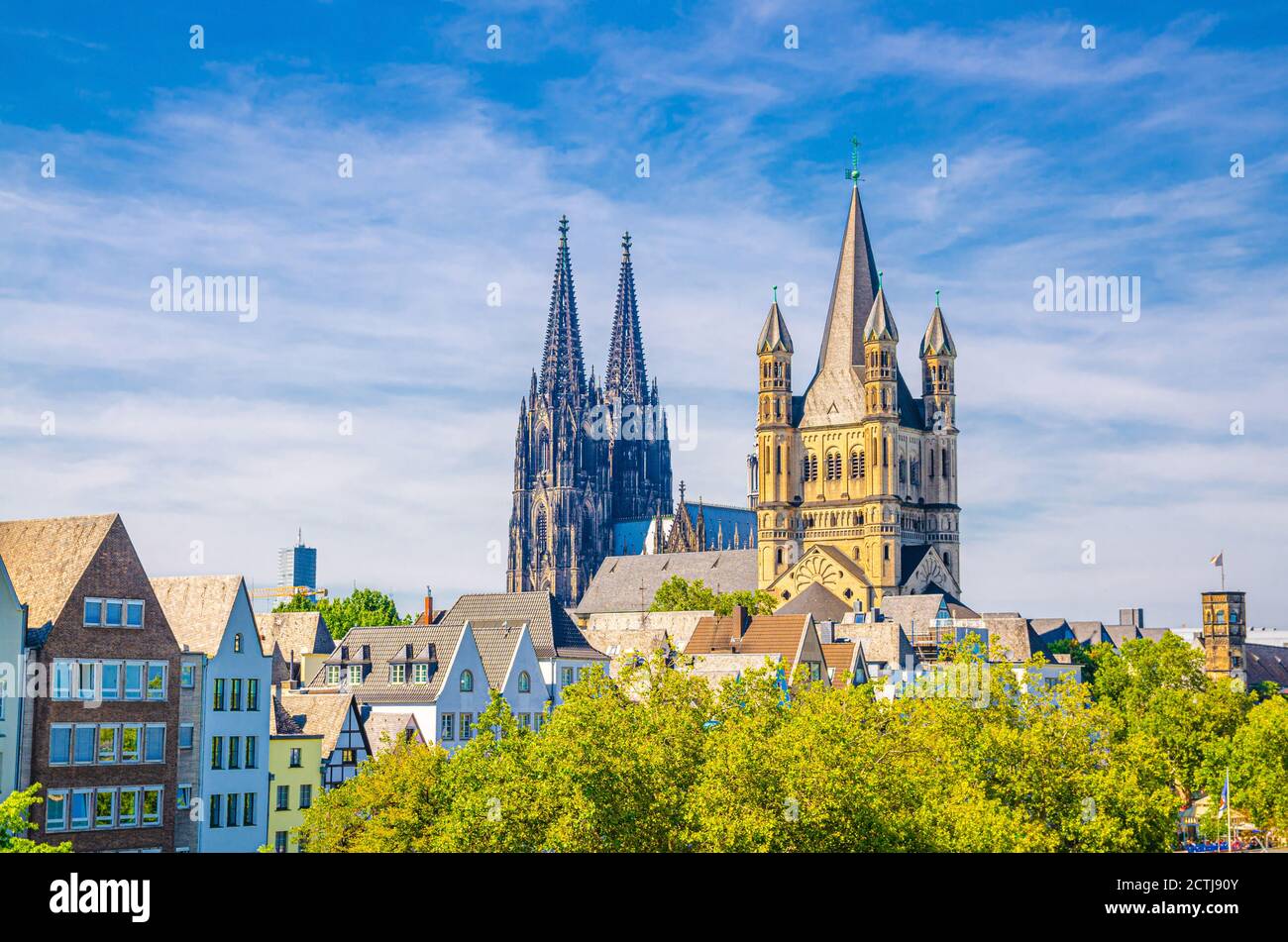 View of historical city centre with towers of Cologne Cathedral of Saint Peter, Great Saint Martin Roman Catholic Church buildings and roofs of colorful houses, North Rhine-Westphalia, Germany Stock Photo