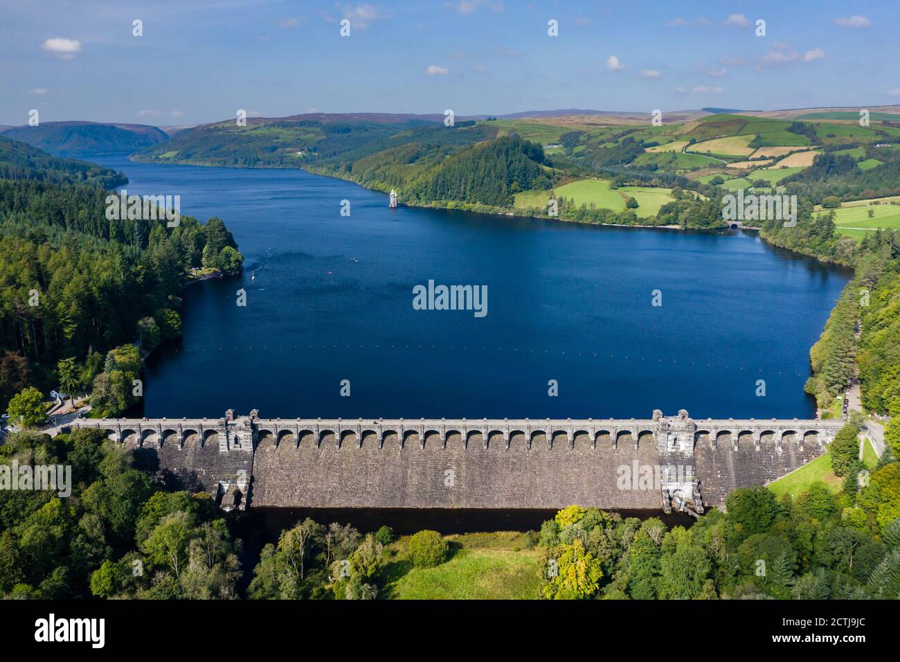 Aerial view of a huge lake surrounded by rural farmland and forest. (Lake Vyrnwy, Wales) Stock Photo