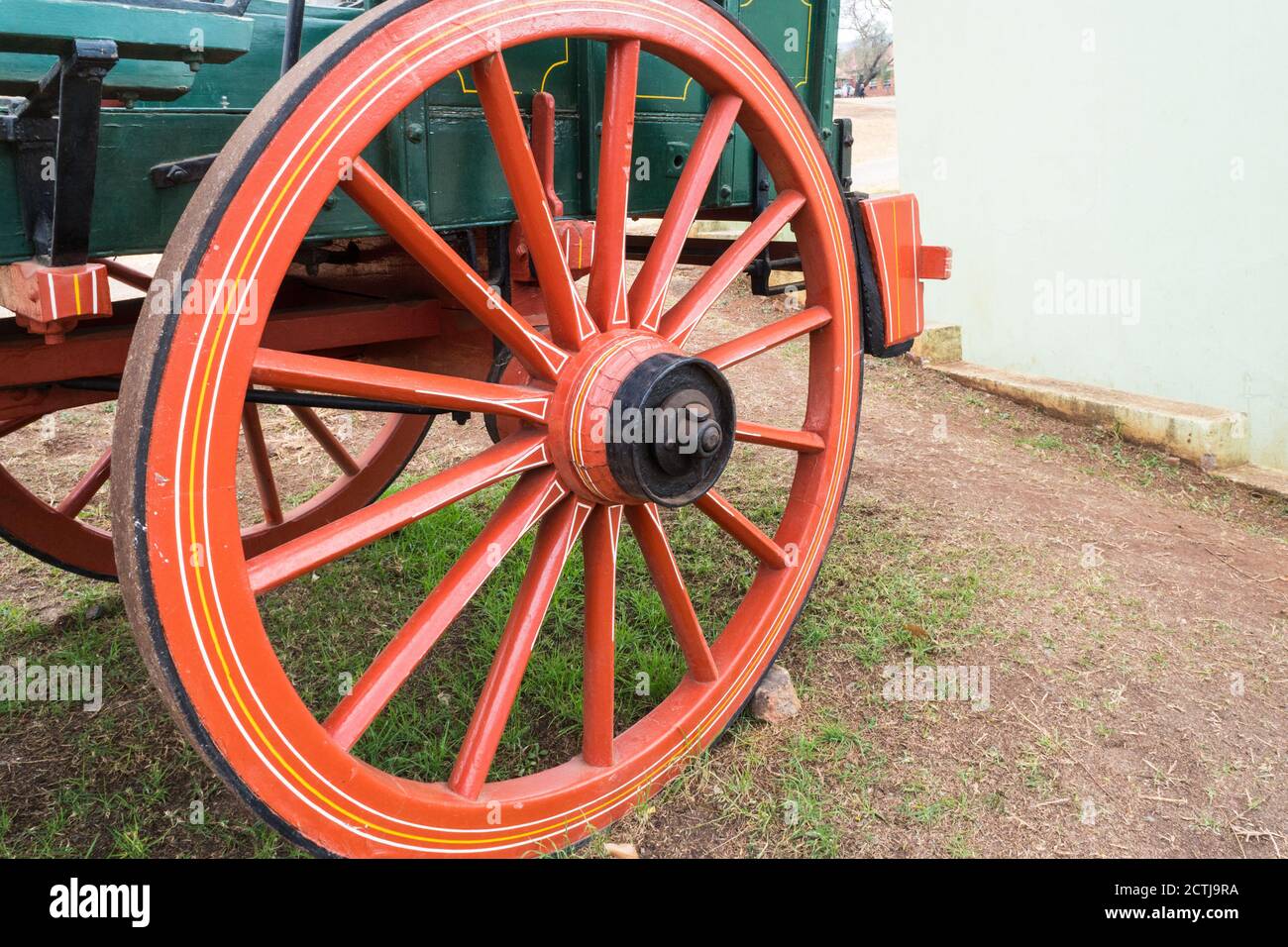 closeup of a red wooden wheel and spokes on an old historical ox wagon