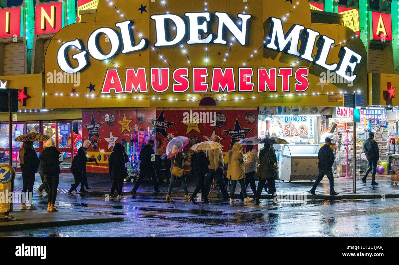 People outside the Golden Mile Amusements in Blackpool. All pubs, bars, restaurants in England must have a 10pm closing time from Thursday, to help curb the spread of coronavirus. Stock Photo