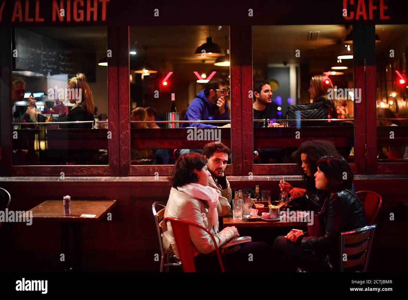 People drinking outside in Soho, London. All pubs, bars, restaurants in England must have a 10pm closing time from Thursday, to help curb the spread of coronavirus. Stock Photo