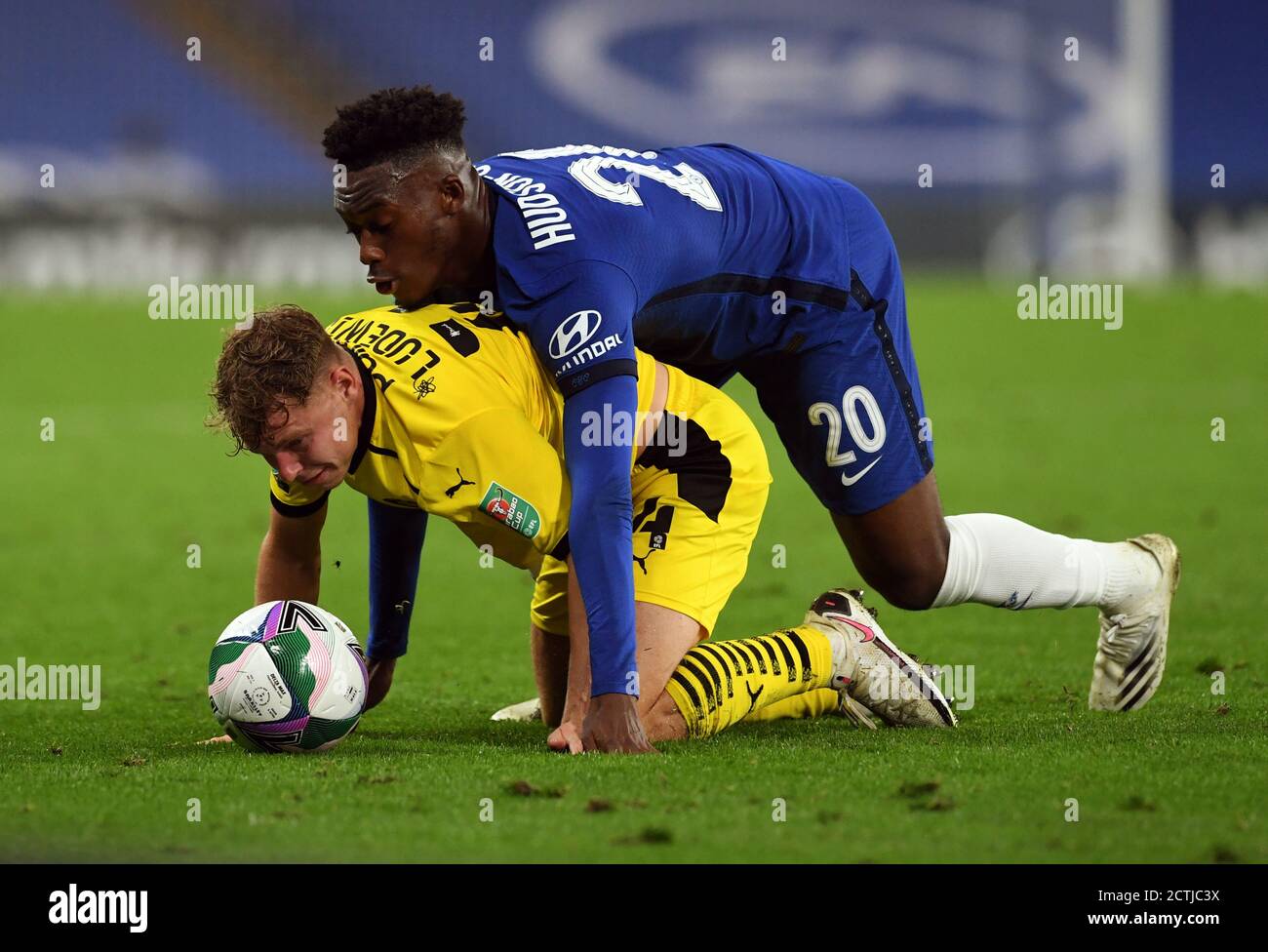 Chelsea's Callum Hudson-Odoi and Barnsley's Kilian Ludewig battle for the ball during the Carabao Cup third round match at Stamford Bridge, London. Stock Photo
