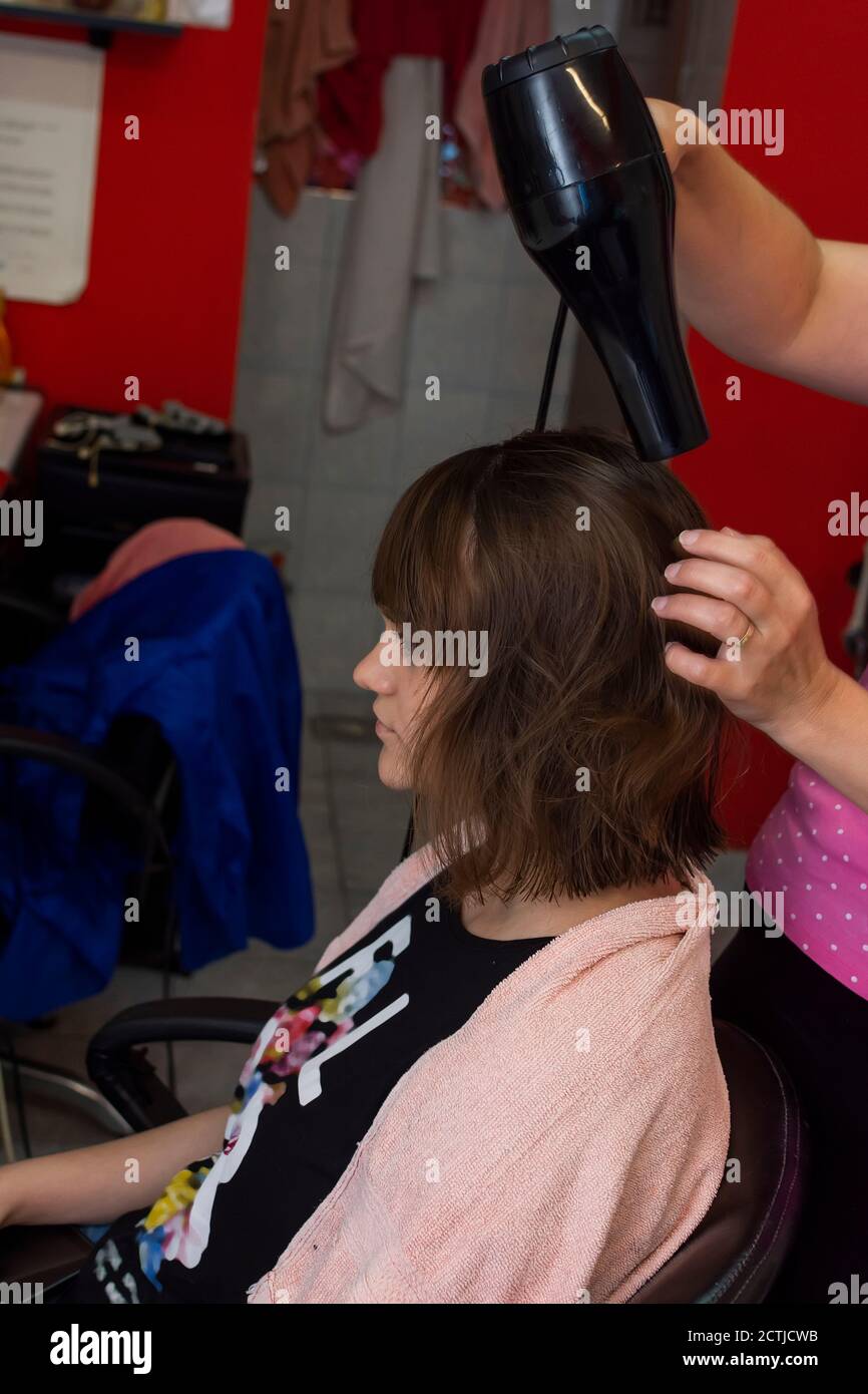 Young girl having a hair dry in the salon Stock Photo - Alamy