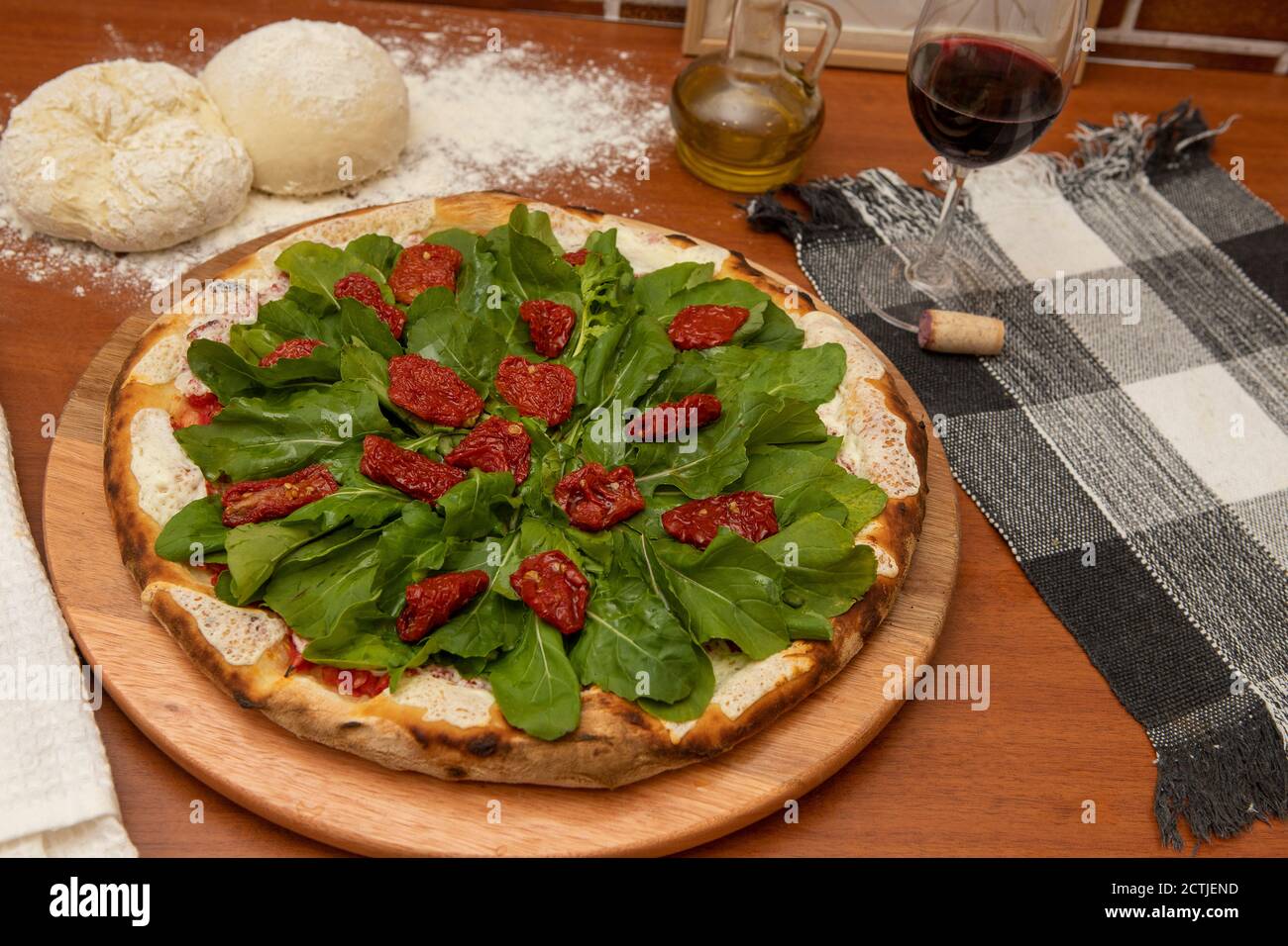Pizza with mozzarella, rucula and dried tomato Stock Photo