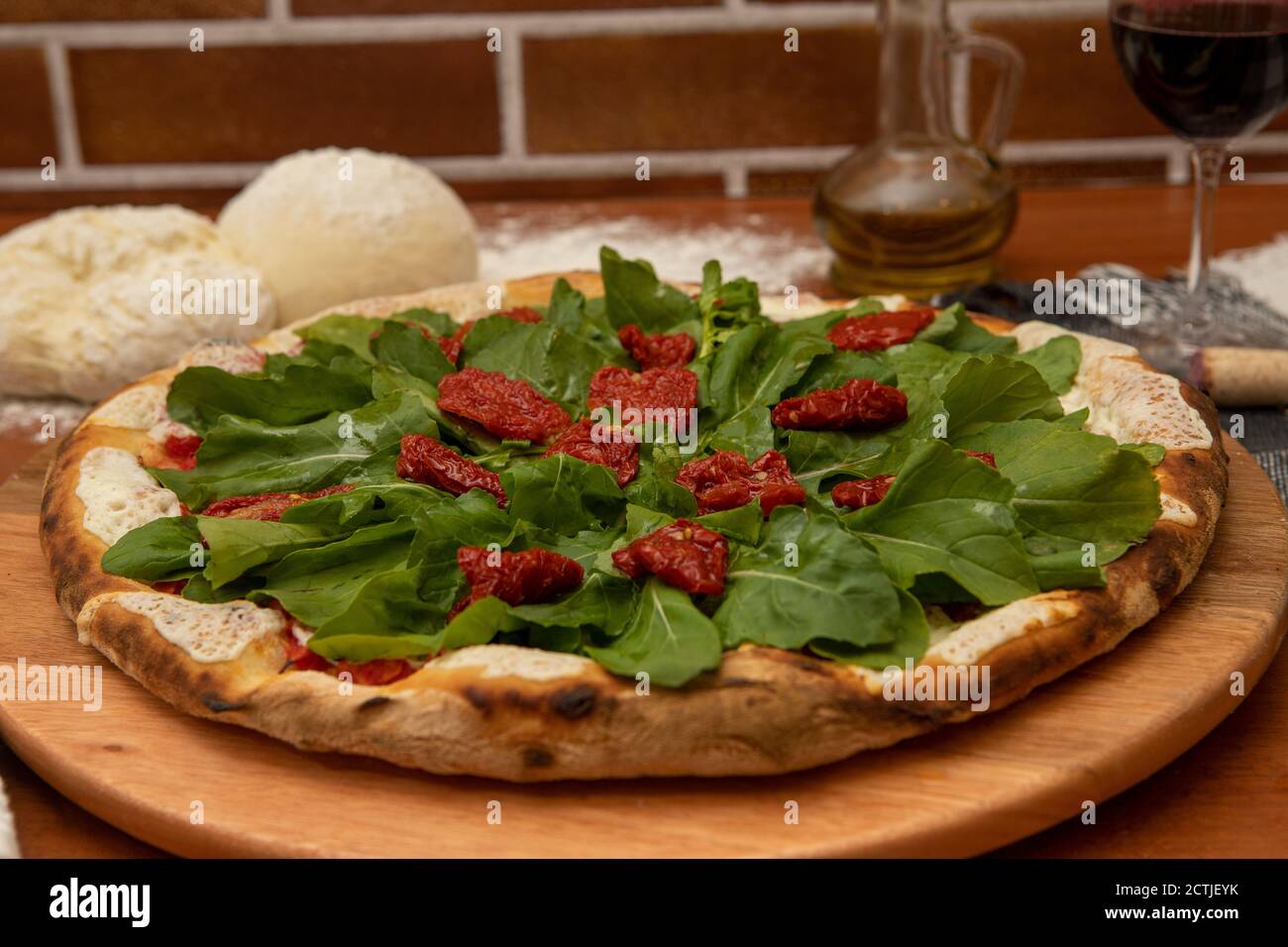 Pizza with mozzarella, rucula and dried tomato Stock Photo