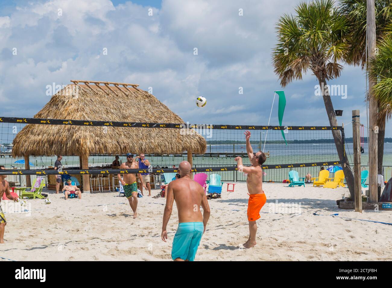 Men playing beach volleyball in Pensacola Beach, Florida, USA Stock