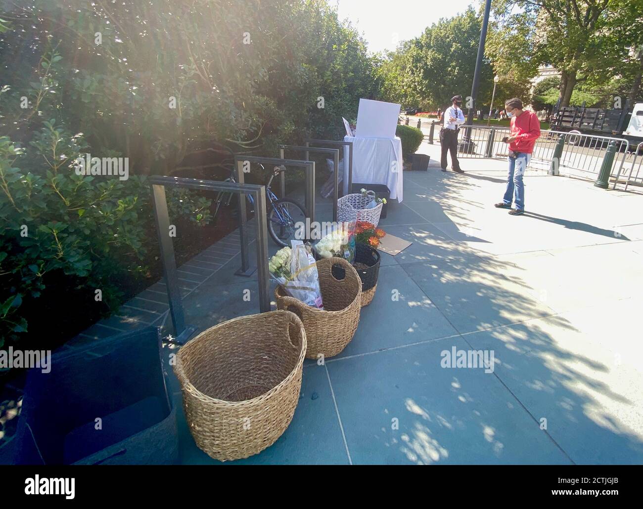 Washington Dc, Washington DC, USA. 23rd Sep, 2020. People set the flowers down in baskets outside the Supreme Court where Ruth Bader Ginsberg's body lies in repose on the Supreme Court Steps, Wednesday, Sept 23 Credit: Amy Katz/ZUMA Wire/Alamy Live News Stock Photo