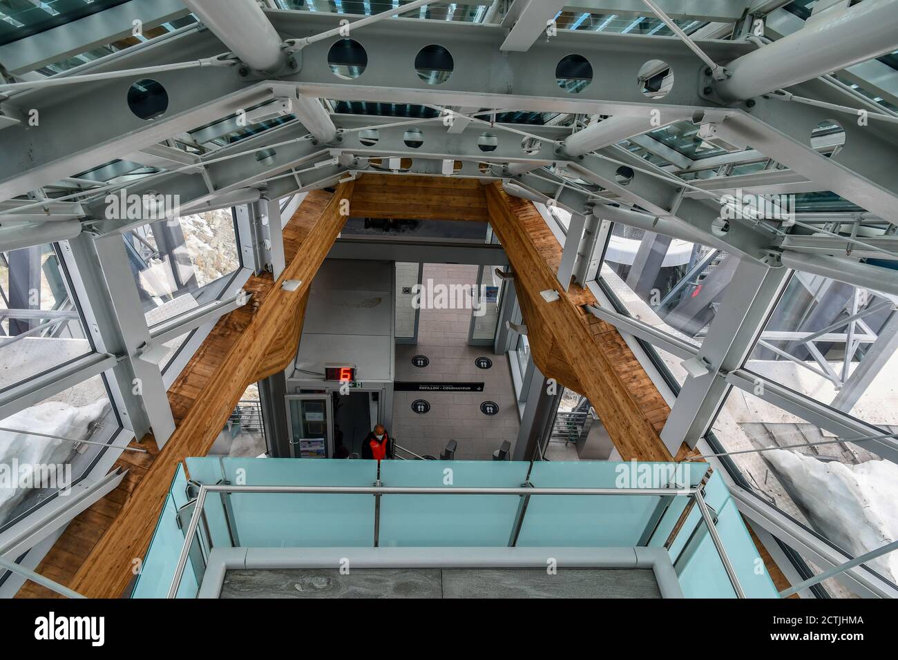 High-angle view of the interior of Pointe Helbronner station of Skyway Monte Bianco cableway with a staffer wearing a Covid-19 mask, Courmayeur, Italy Stock Photo