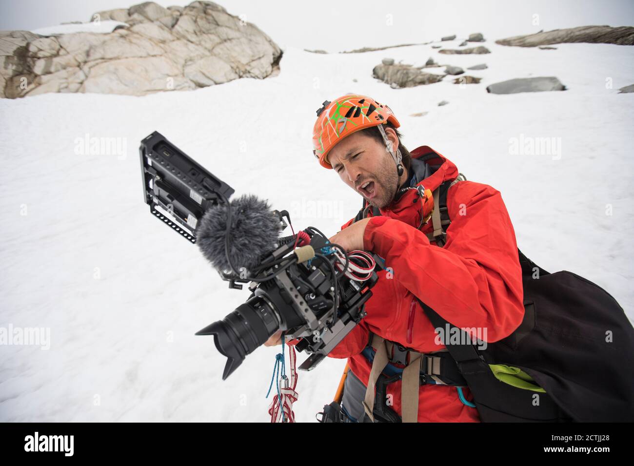 Film maker watches his playback screen in awe of the footage he shot. Stock Photo