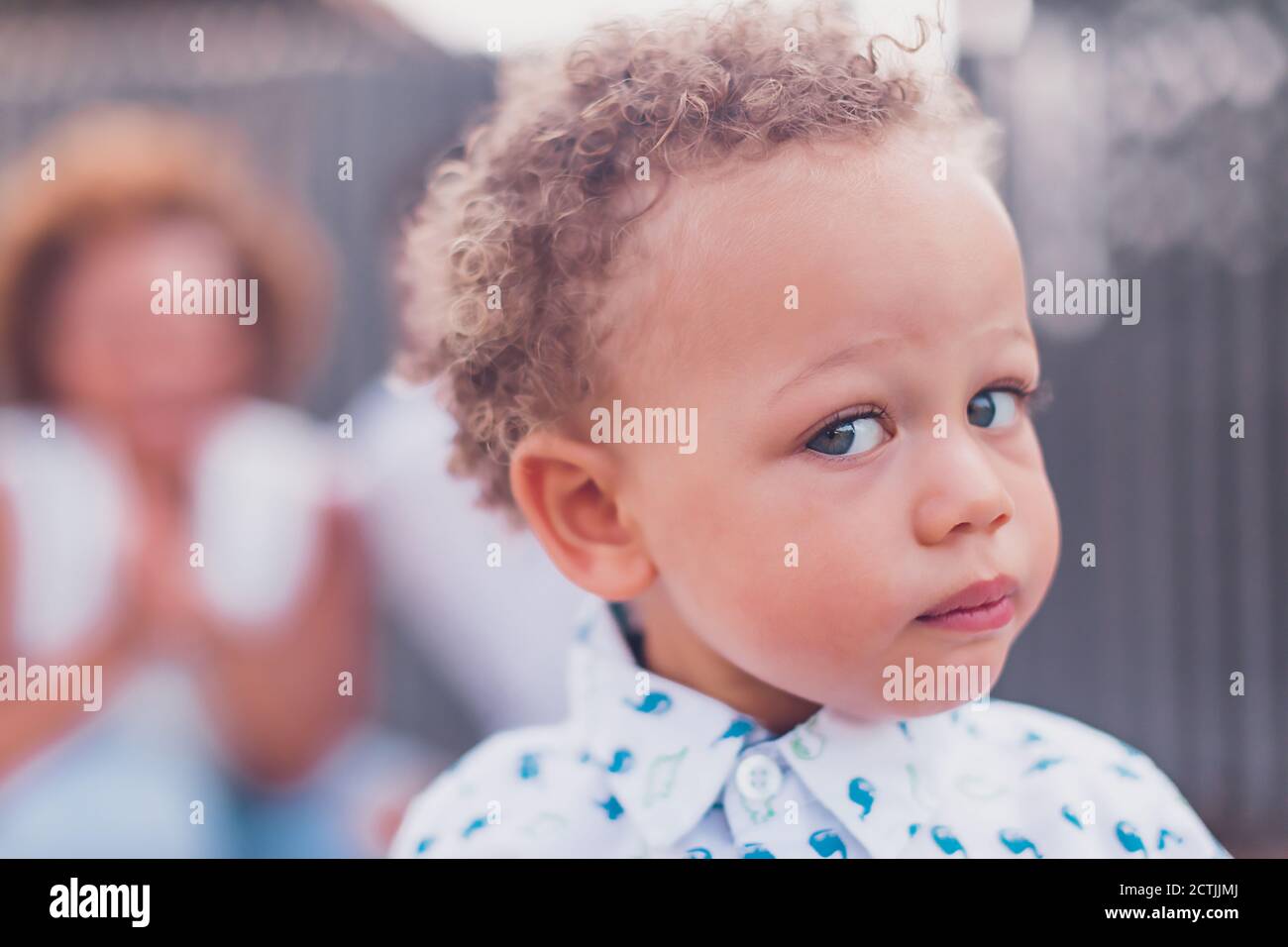 Mixed race baby boy with blue eyes looking at camera Stock Photo - Alamy