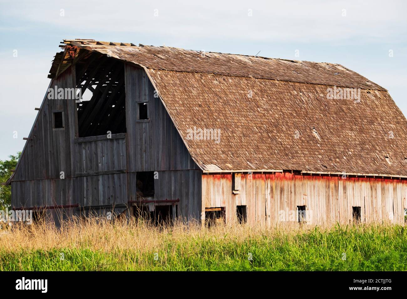An old abandoned dilapidated wooden barn in the Oklahoma countryside in the late spring. USA. Stock Photo