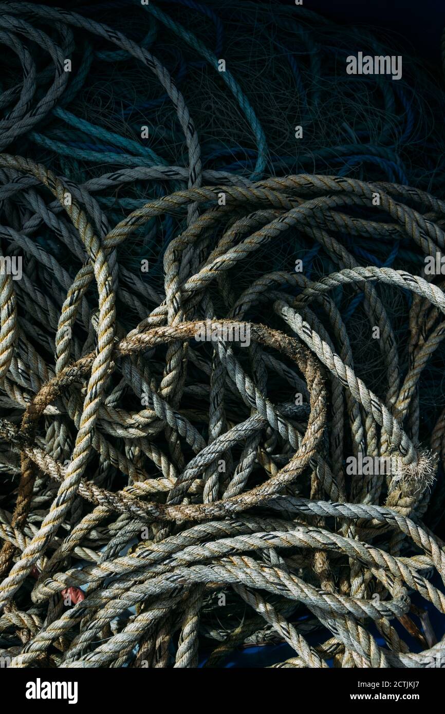 Vertical shot of old fishing ropes and nets under the sunlight Stock ...