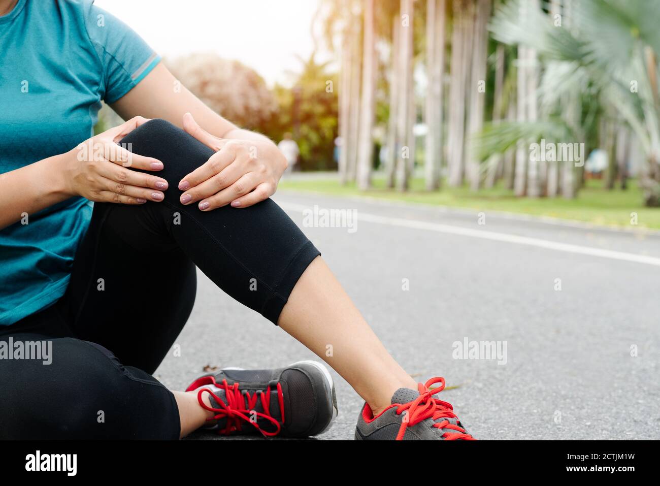 fitness woman runner feel pain on knee. Outdoor exercise activities