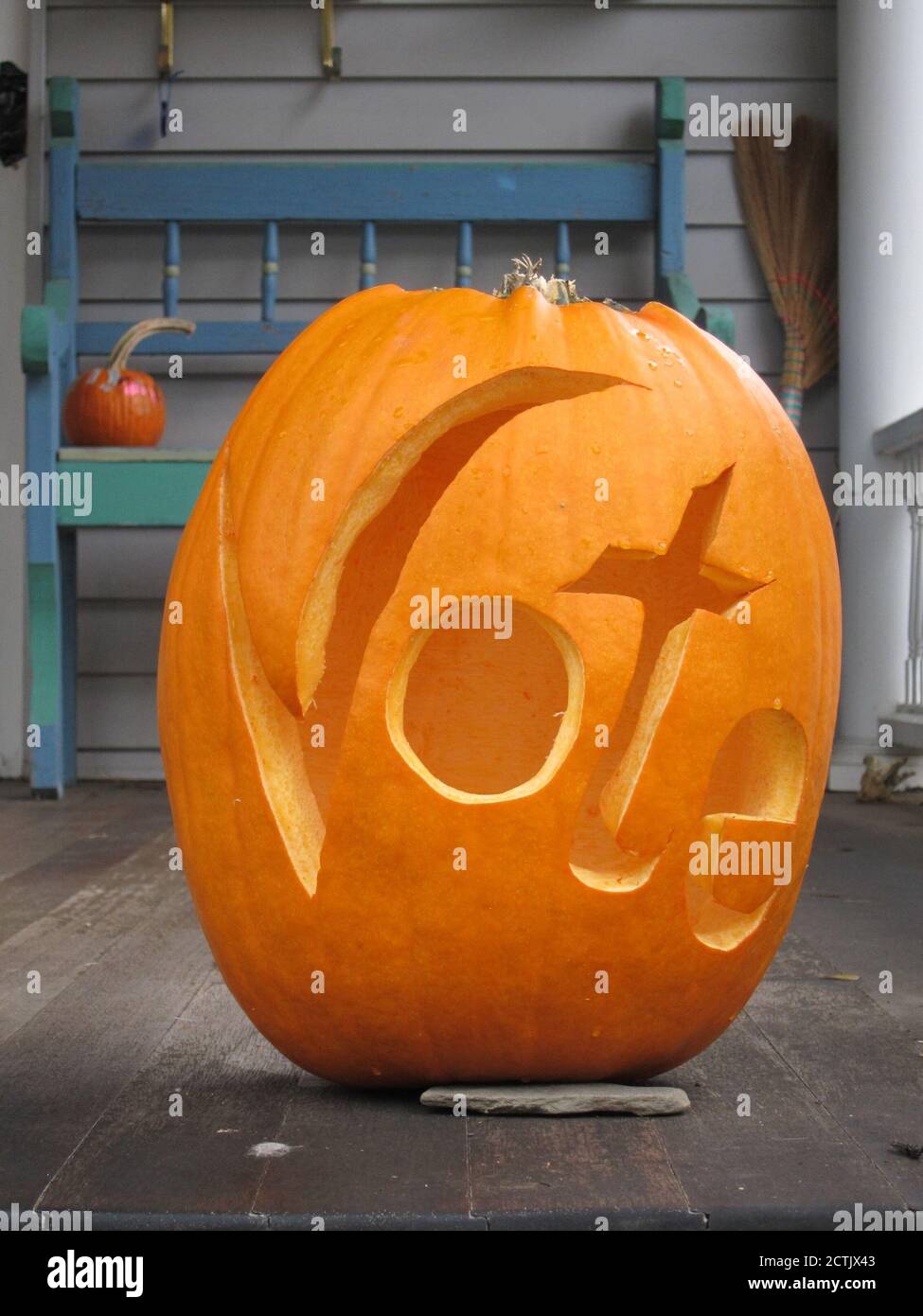A Halloween Jack O' Lantern is carved with the word Vote due to the proximity of Halloween and Election Day in the United States of America Stock Photo