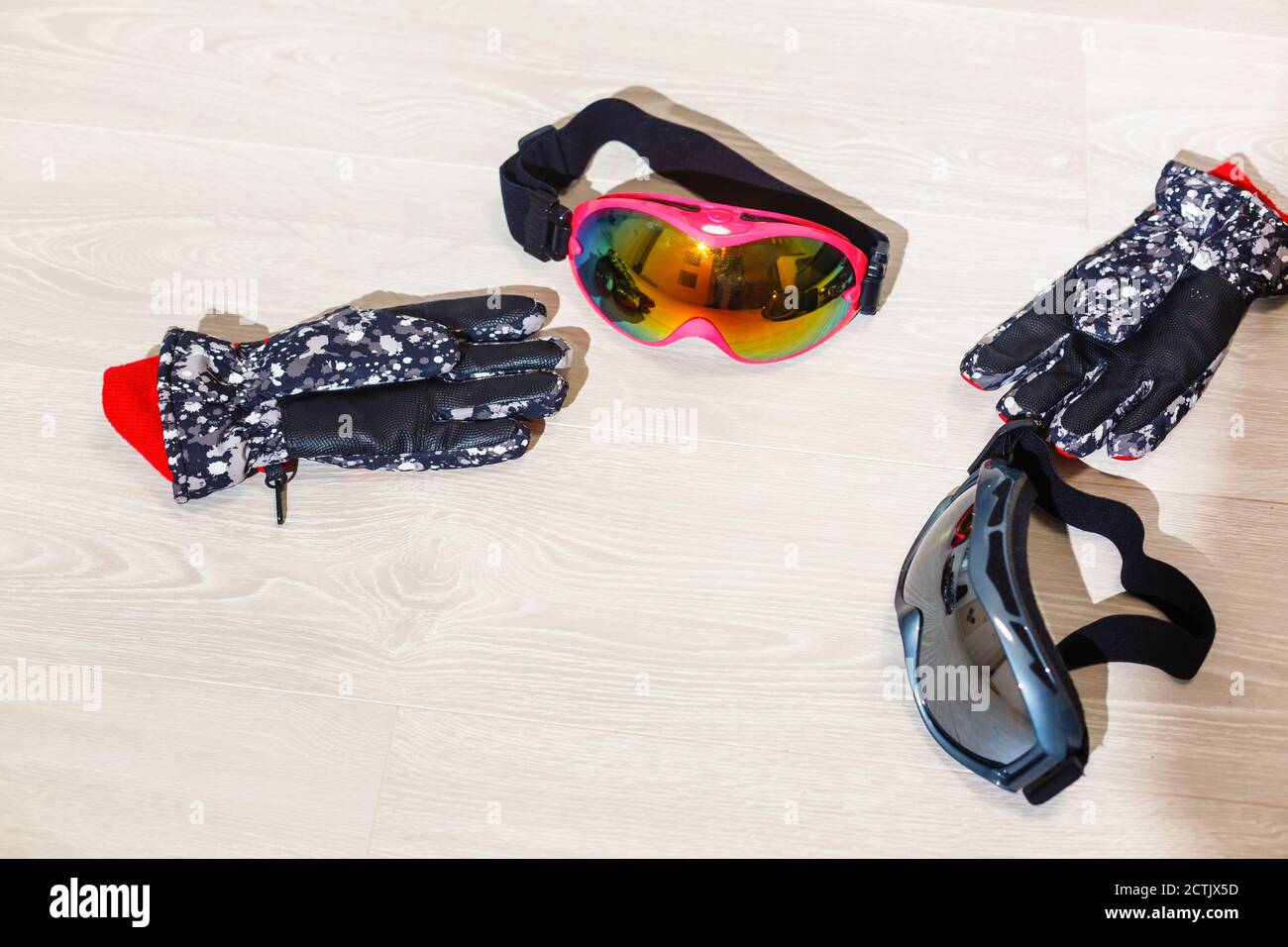 Ski goggles and winter gloves on white background Stock Photo