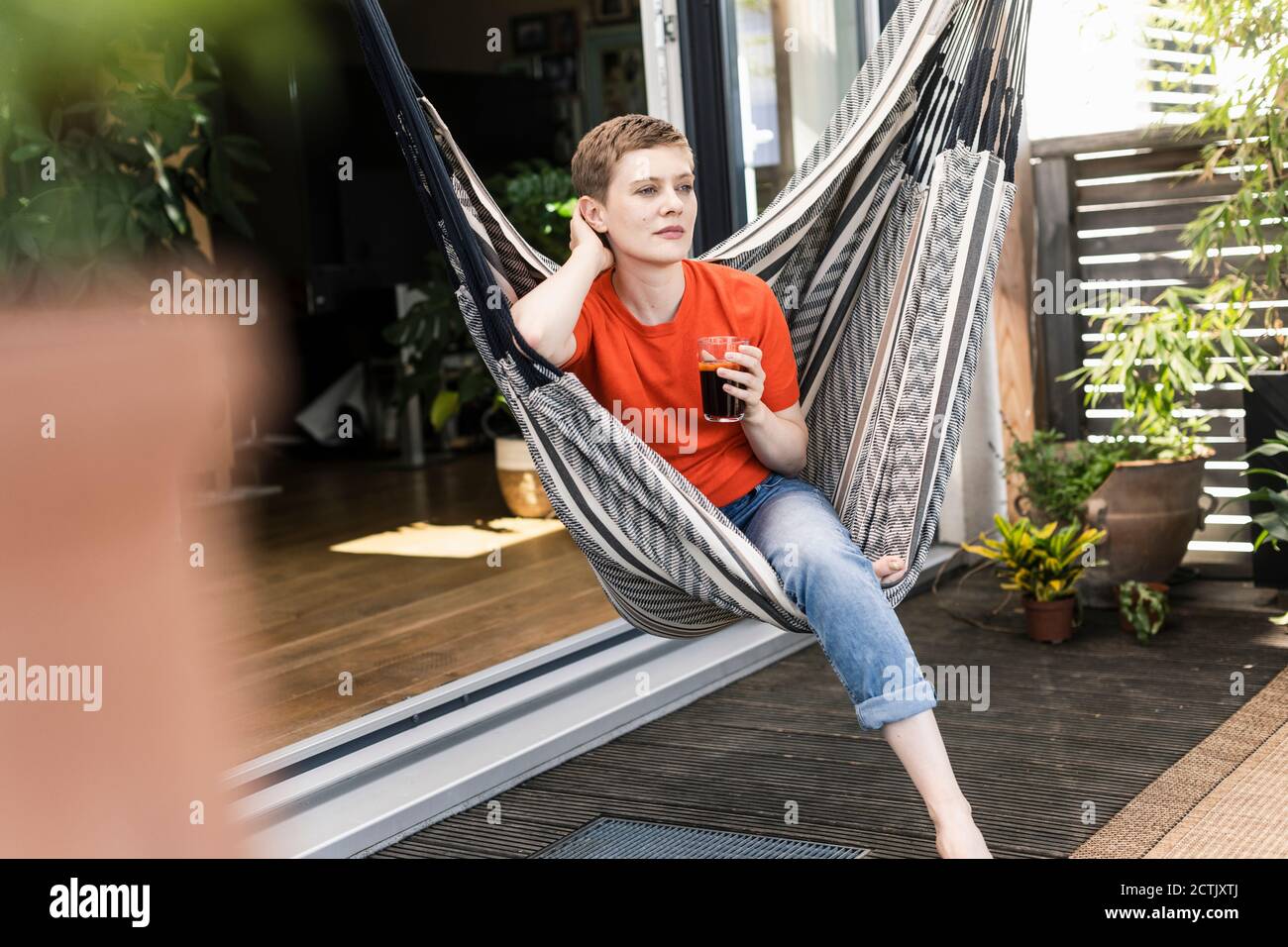 Woman sitting on porch veranda hi-res stock photography and images - Alamy