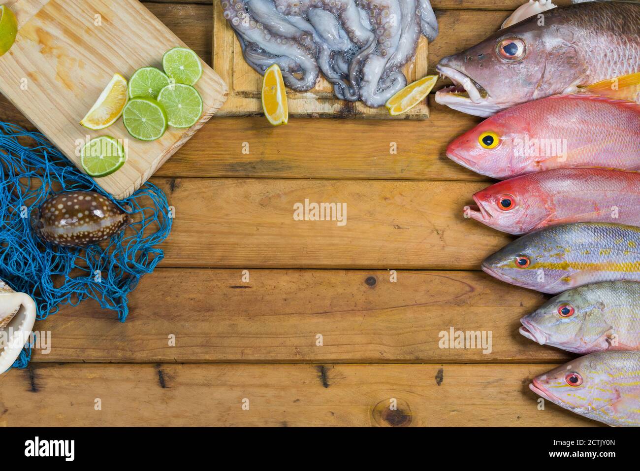 Caribbean Fresh fish seafood on old wooden table. Top view. Closeup