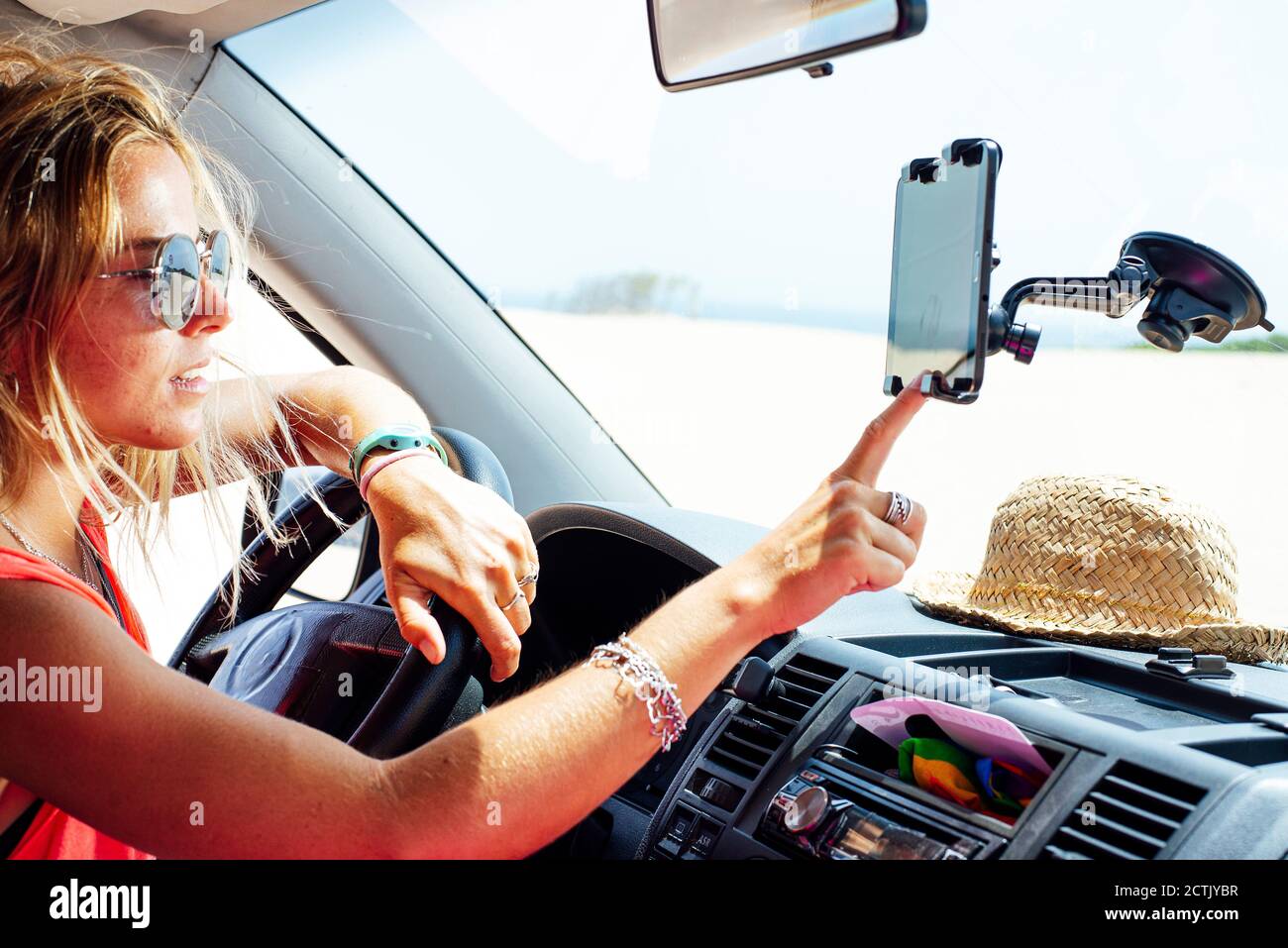 Woman using navigation on smart phone while sitting in van Stock Photo
