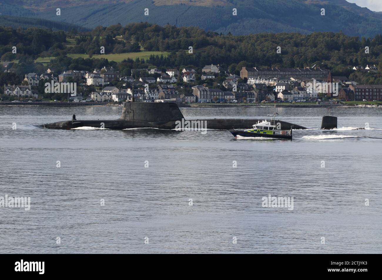 An Astute-class submarine operated by the Royal Navy, heading down the  Firth of Clyde shortly after departing from its Faslane base, with a  Ministry of Defence Police escort in the shape of