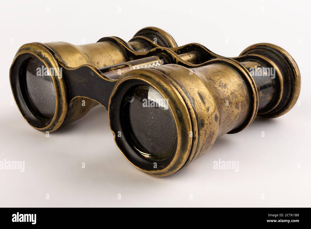 Old and used brass binoculars with dust and scratches Stock Photo