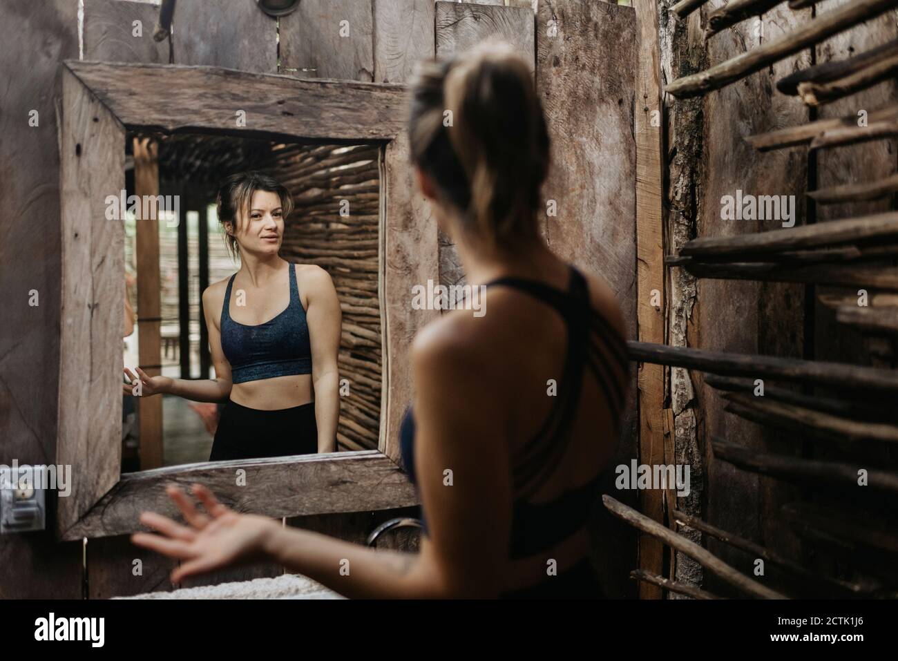 Smiling woman looking in mirror Stock Photo