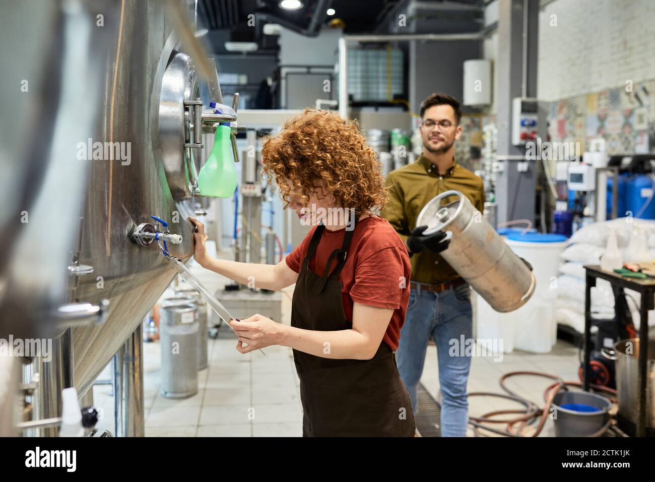 Man and woman working in craft brewery Stock Photo