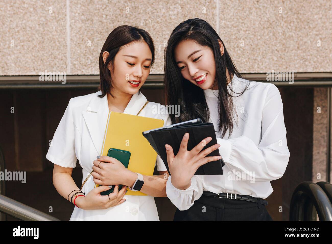 Colleagues working together on digital tablet Stock Photo