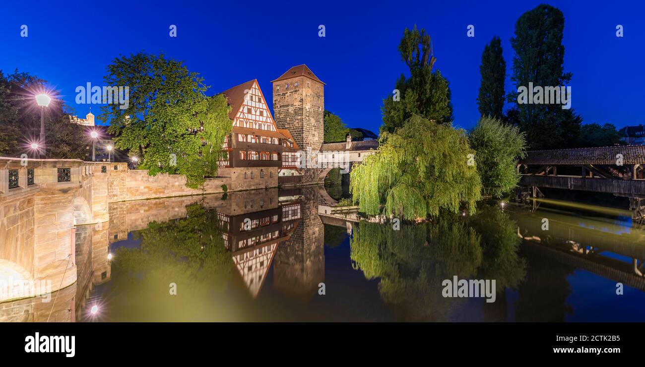 Germany, Bavaria, Nuremberg, Panorama of river Pegnitz, Weinstadel and Wasserturm at night Stock Photo
