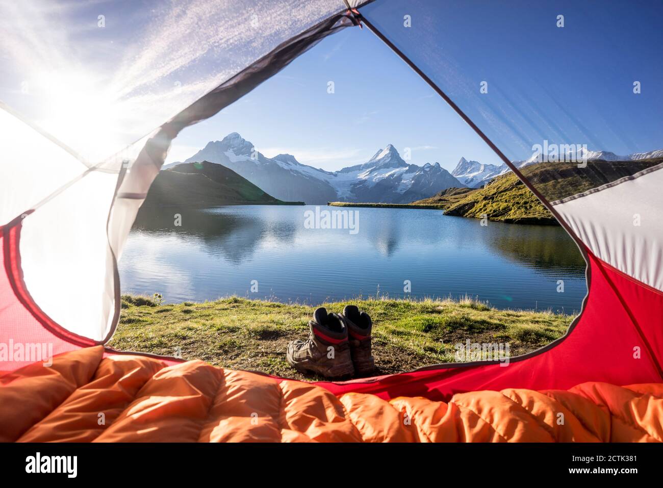 Tent pitched on shore of Bachalpsee at sunrise Stock Photo